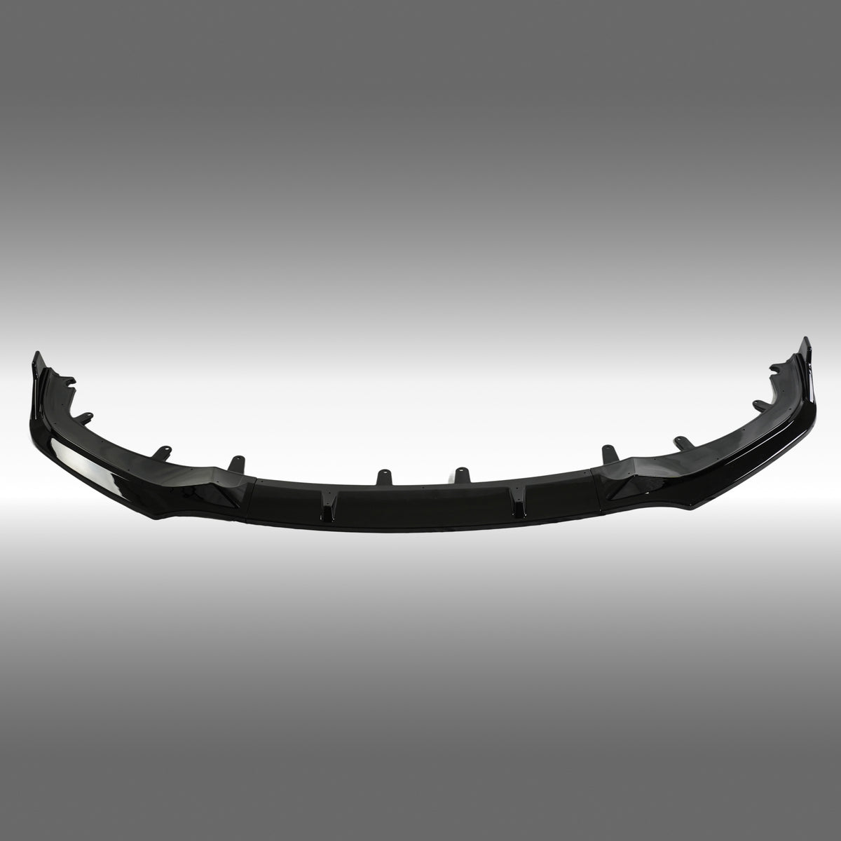Standalone view of the uninstalled NexaNovo gloss black front bumper lip for BMW 8 Series G16