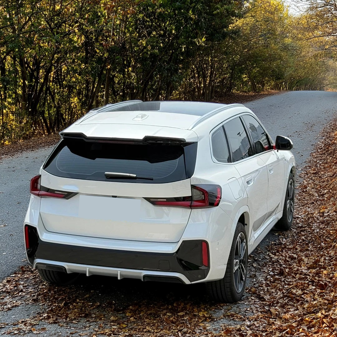 BMW X1 U11 in motion with VTEN gloss black roof spoiler
