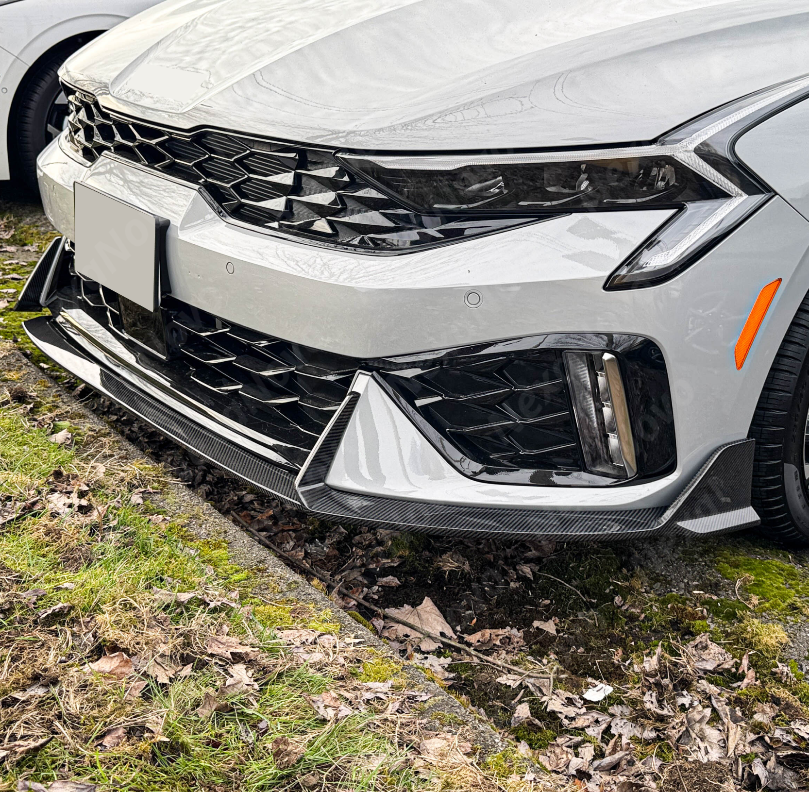 Carbon fiber front bumper lip for 2025 Kia K5 with aggressive styling by NexaNovo.