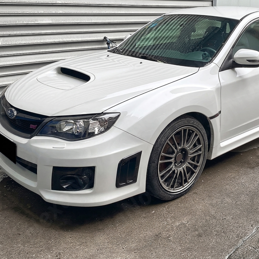 Pair of gloss black front bumper side air vents installed on a 2011 Subaru WRX STI GV