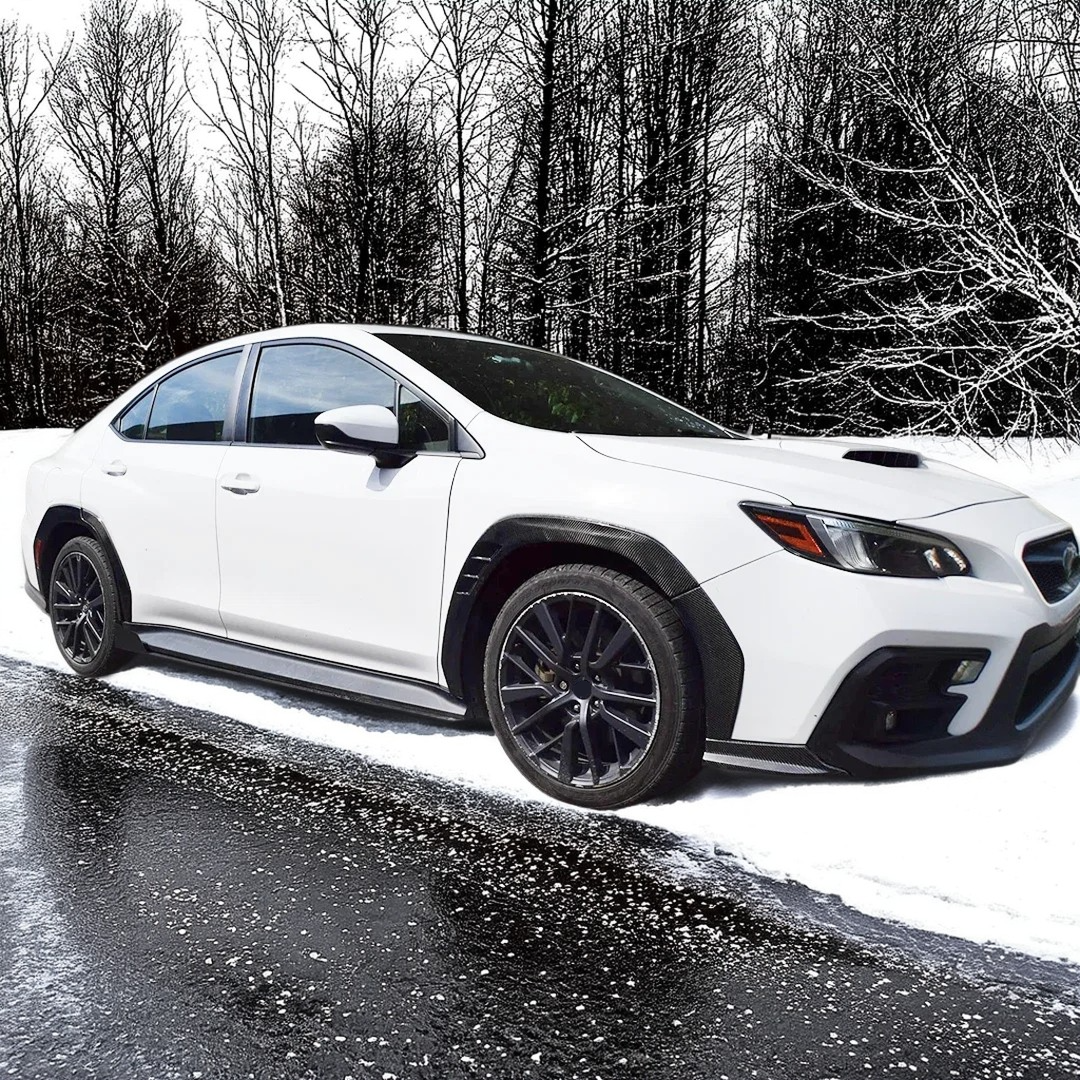 Detailed view showing the precise fitment of the front fender flares on the Subaru WRX body panel
