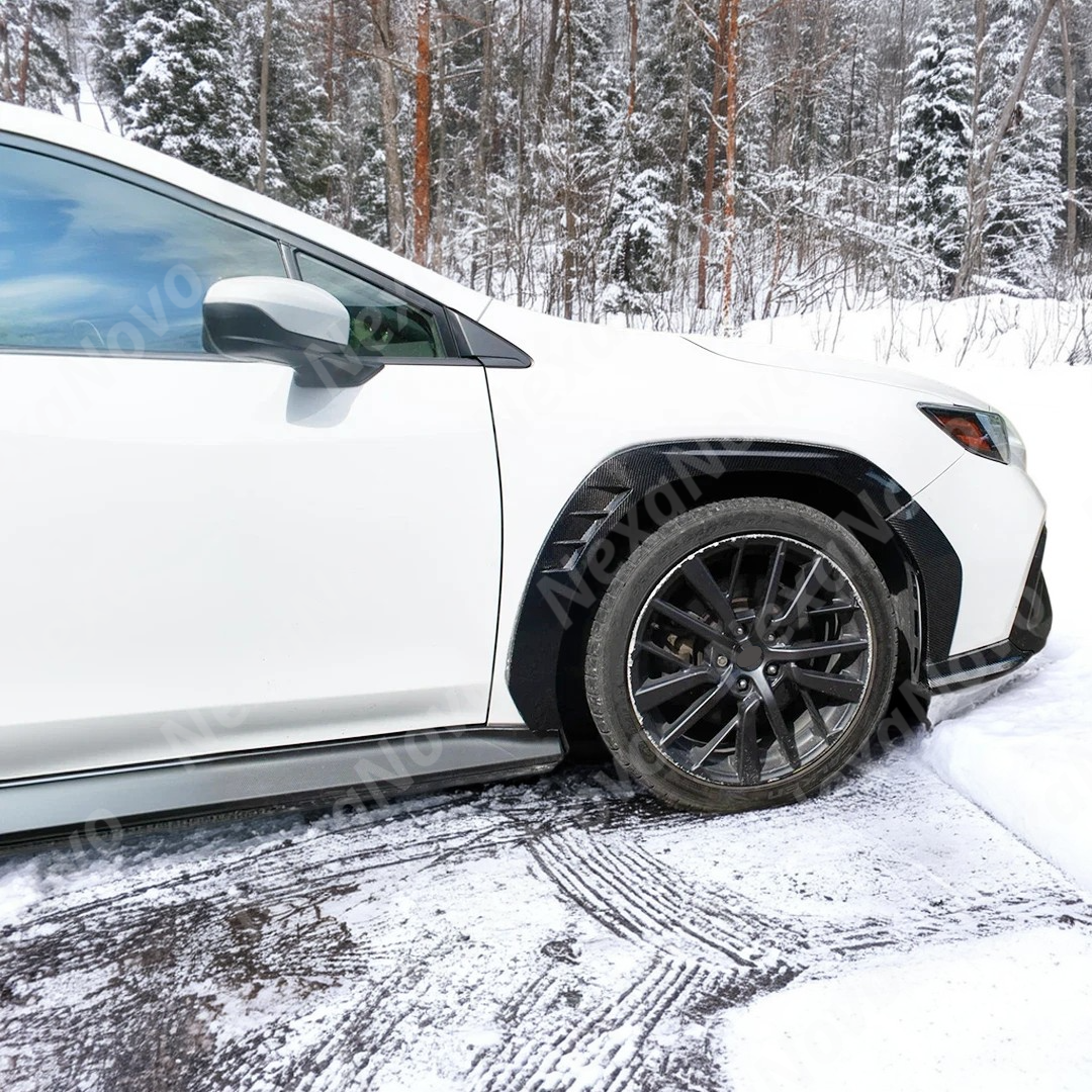 A pair of uninstalled real carbon fiber front fender flares for the Subaru WRX