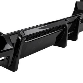 High-contrast stance of the NexaNovo VTEN gloss black rear diffuser accenting a Brooklyn Grey 2025 BMW G60