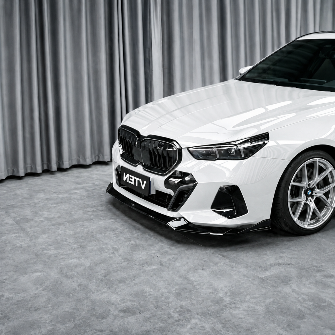 Detailed close-up of the mirror-finish gloss black clear coat on the NexaNovo front lip splitter