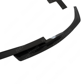 Low angle detail of the aggressive real carbon fiber front bumper lip splitter included in the 3-in-1 kit