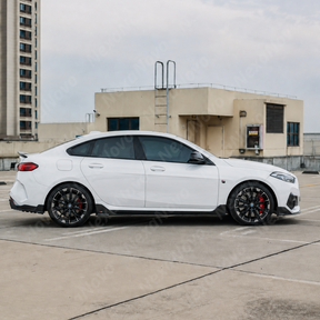 High-gloss black VTEN side skirts creating sharp lower body contrast on a Thundernight Metallic BMW 2 Series F74