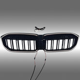 NexaNovo gloss black double-slat LED illuminated grille glowing on a 2023 BMW 3 Series G20