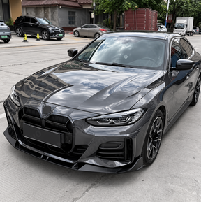 Direct front-facing perspective highlighting the road-hugging chin spoiler and sculpted aerodynamic profile on a BMW M440i Gran Coupe