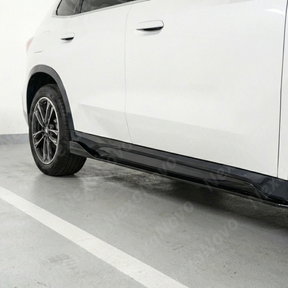 Full 3/4 view of a 2024 BMW X1 featuring NexaNovo gloss black side skirt under spoilers