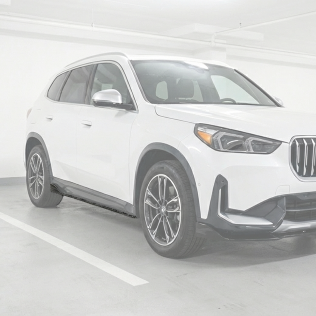 Custom BMW X1 on a showroom floor featuring NexaNovo side skirt upgrades