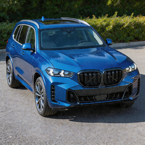 High-impact front view of a 2025 BMW X5 featuring the NexaNovo gloss black grille upgrade