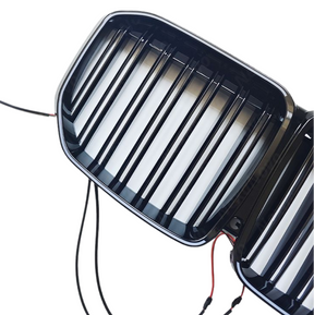 Close-up of the integrated LED light bar and mirror-finish gloss black on the NexaNovo X7 grille