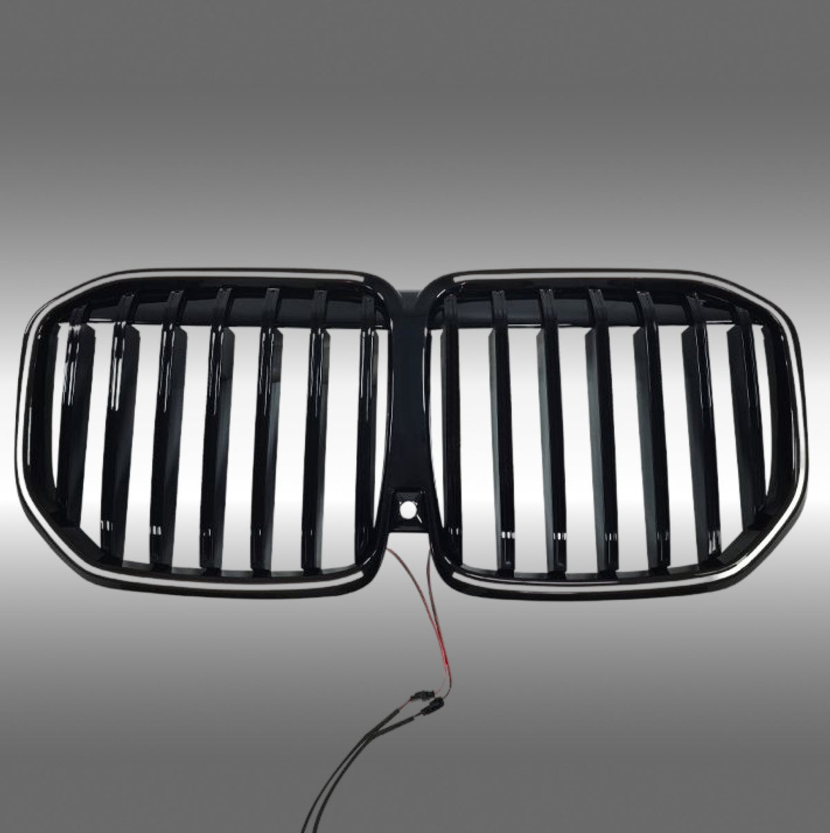 NexaNovo gloss black single-piece LED illuminated grille glowing on a 2023 BMW X7 G07