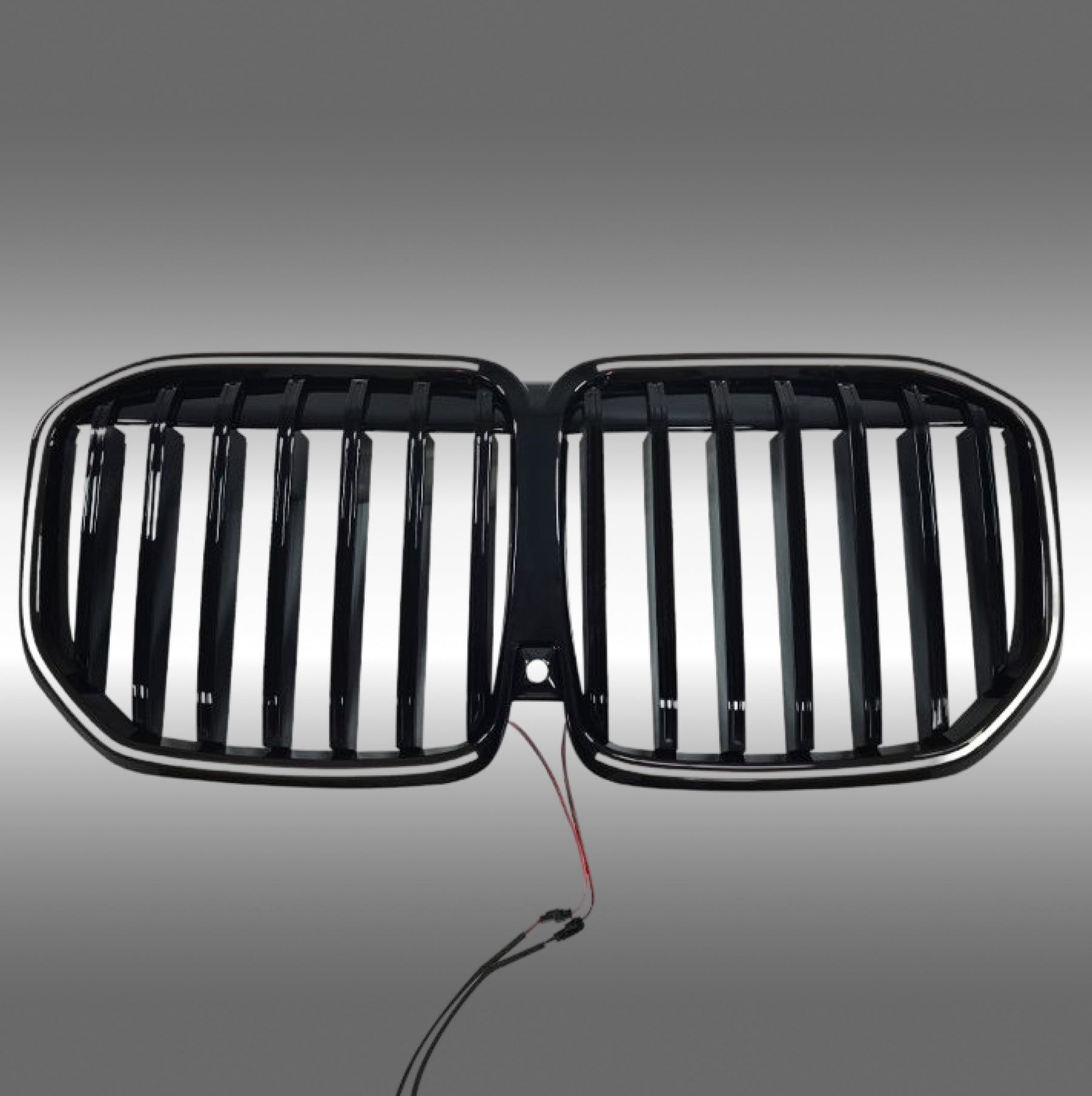 NexaNovo gloss black single-piece LED illuminated grille glowing on a 2023 BMW X7 G07