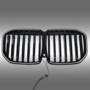 NexaNovo gloss black single-piece LED illuminated grille glowing on a 2023 BMW X7 G07