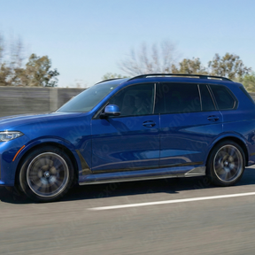 Full 3/4 view of a 2021 BMW X7 M50i featuring NexaNovo double-sided real carbon fiber rockers