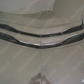 Underside view of uninstalled NexaNovo carbon fiber hood cover showing mounting points

