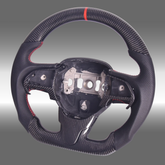 Custom 3K gloss carbon fiber sport steering wheel with perforated leather and red center stripe installed in a Chrysler 300 cockpit