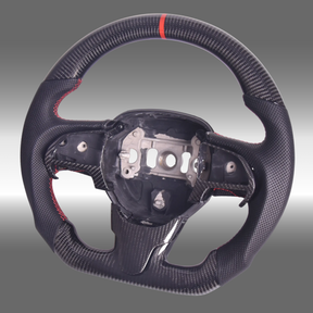 Custom 3K gloss carbon fiber sport steering wheel with perforated leather and red center stripe installed in a Chrysler 300 cockpit