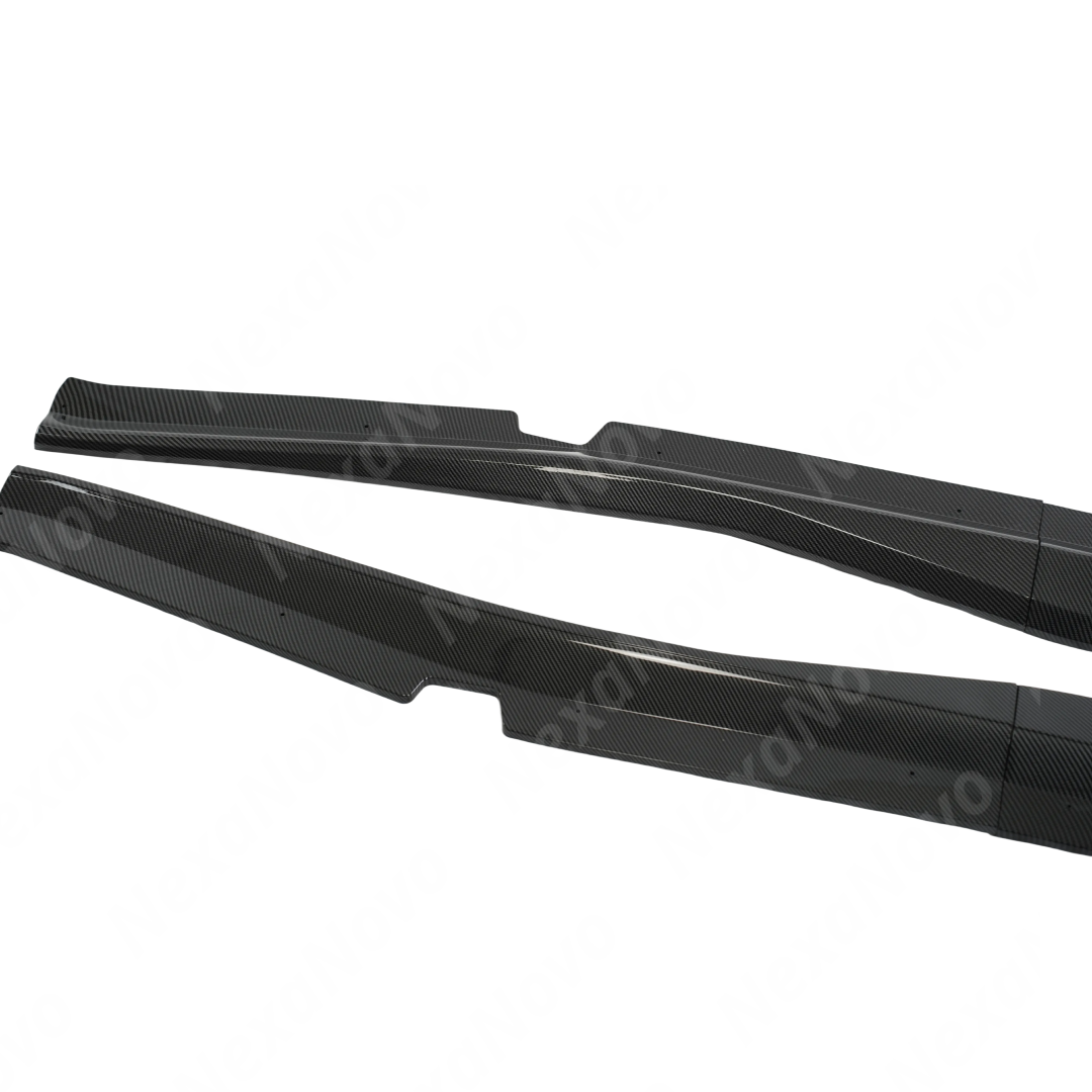 Two carbon fiber car side skirts on a white background