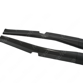 Two carbon fiber car side skirts on a white background