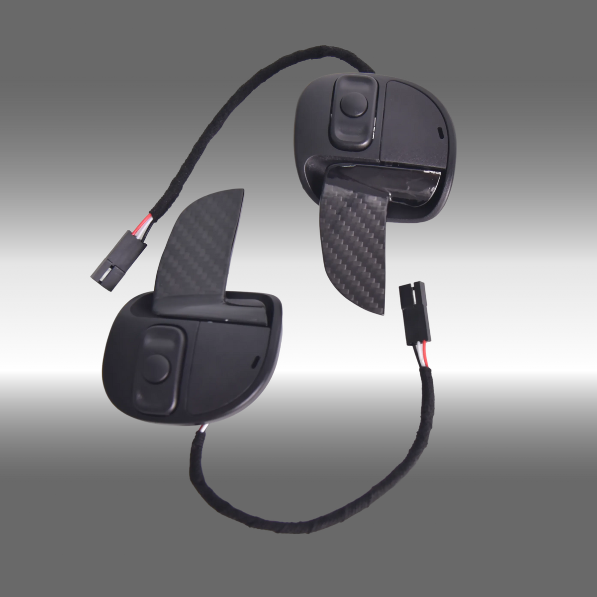 Full replacement gloss carbon fiber paddle shifters installed on an SRT steering wheel inside a Dodge Challenger cockpit