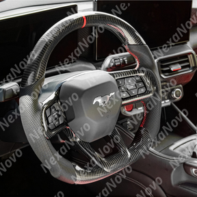 Wide-angle interior shot displaying the gloss carbon fiber wheel integrating with the modern S650 cockpit and center console