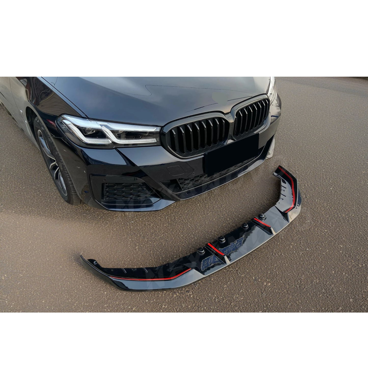 Detailed image of the Gloss Black Front Lip by NexaNovo on a 2021-2024 BMW 5 Series G30 LCI, featuring the lip front design for improved downforce