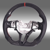Custom 3K gloss carbon fiber sport steering wheel with perforated leather and red center stripe installed in an Elantra N cockpit