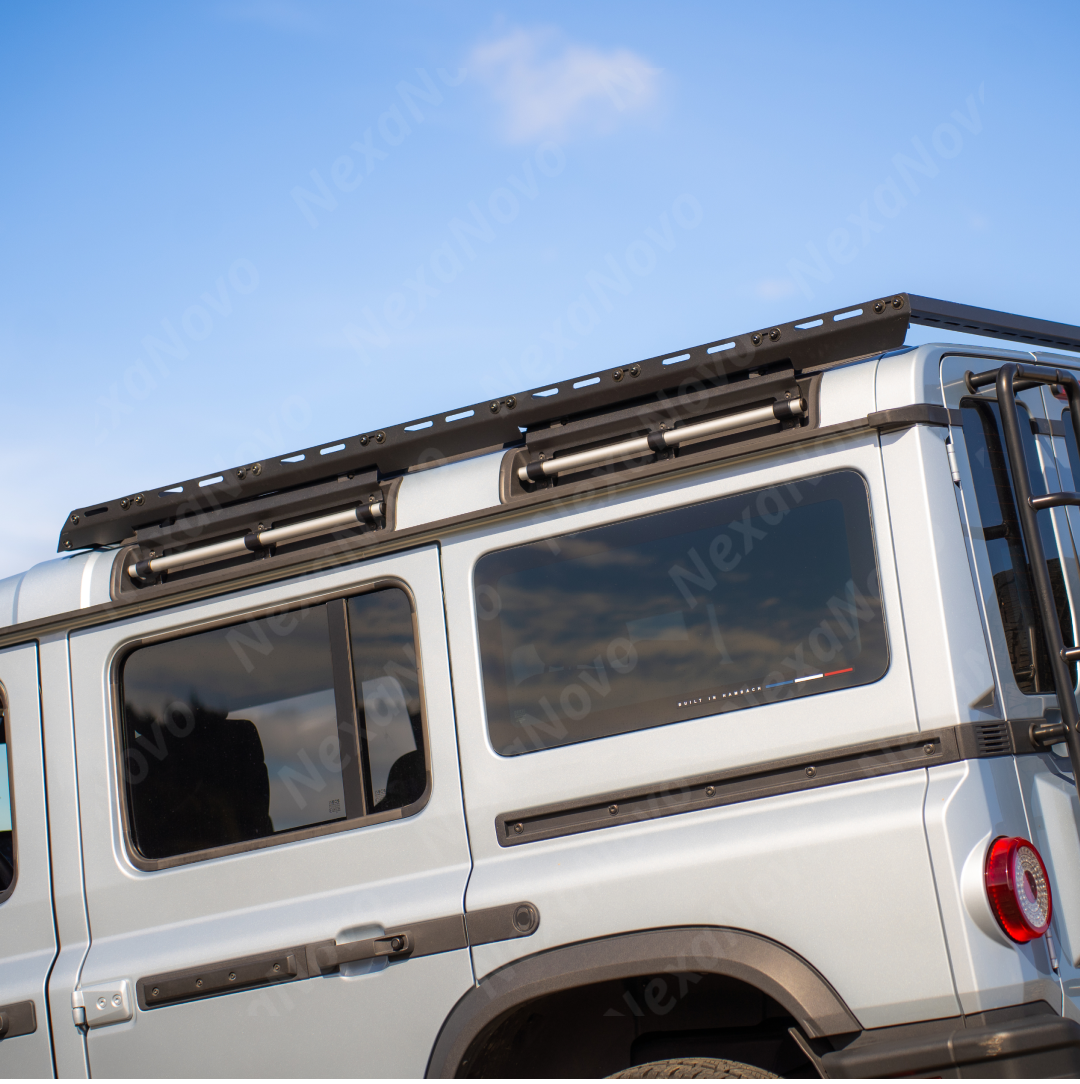 Hard-shell overland rooftop tent securely mounted to the NexaNovo platform on a 2026 Grenadier