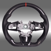 Custom 3K gloss carbon fiber sport steering wheel with perforated leather and red center stripe installed in a Kia Stinger GT cockpit