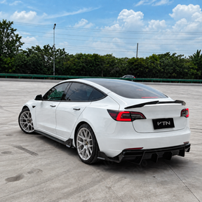 High-contrast styling of piano gloss black VTEN side skirts mounted on a Pearl White Multi-Coat Tesla Model 3