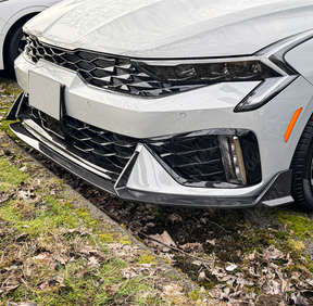 Carbon fiber front bumper lip for 2025 Kia K5 with aggressive styling by NexaNovo.
