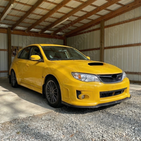 Showing the high-reflectivity clear coat on the NexaNovo gloss black STI front lip