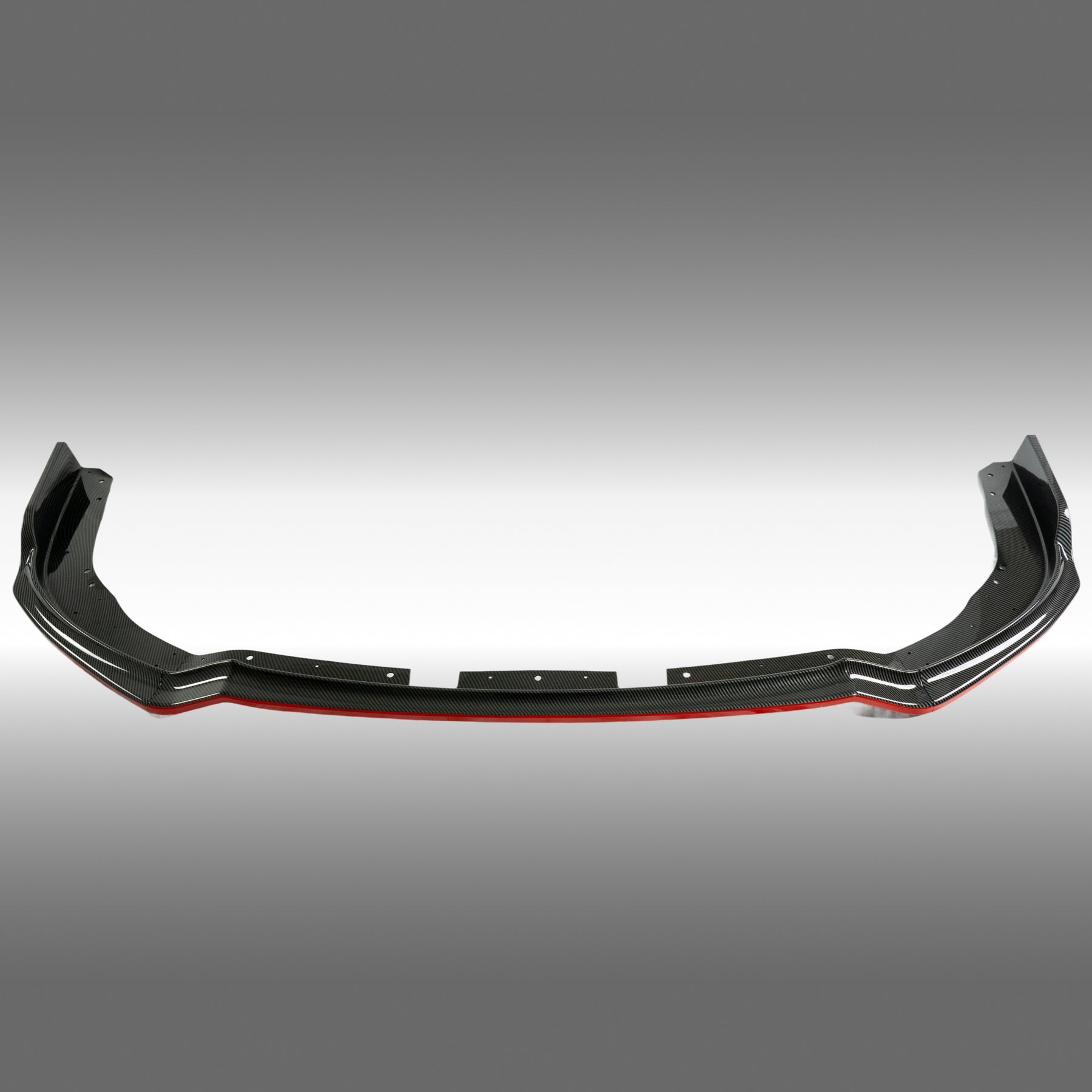 Carbon fiber print front splitter lip with red accent trim installed on a 2011 Subaru Impreza WRX STI