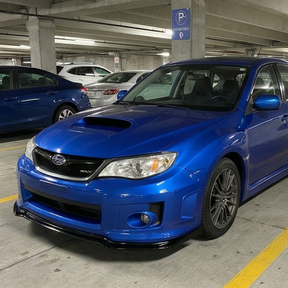 Gloss black front bumper lip splitter installed on a 2011 Subaru Impreza WRX STI