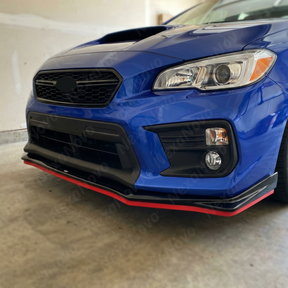 Full 3/4 view of a 2012 Subaru WRX STI with the red-accented gloss black front lip kit