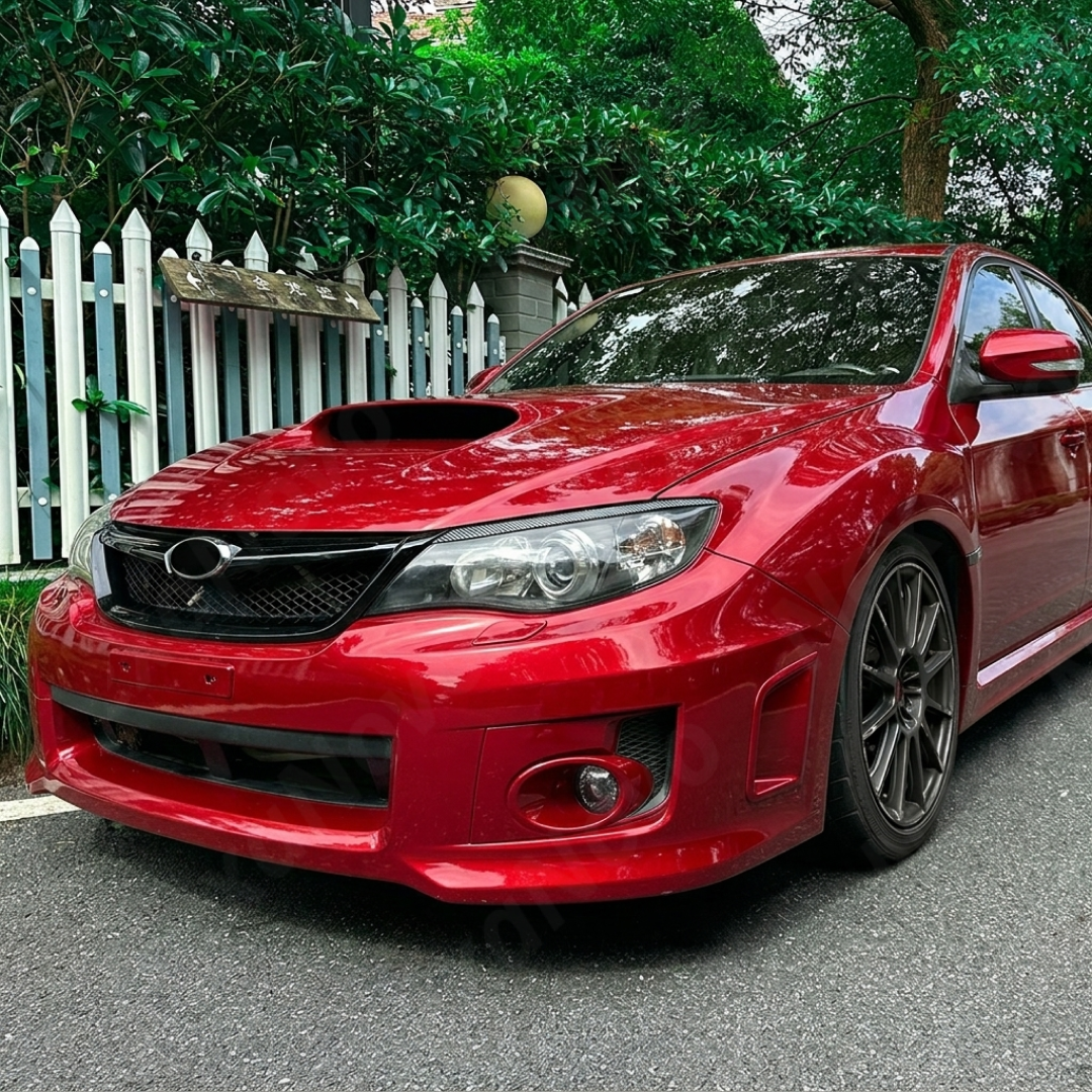 Pair of gloss black headlight eyelid overlays installed on a 2011 Subaru WRX STI GV sedan