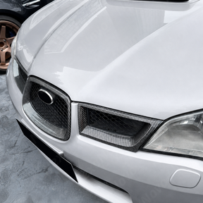 Aggressive carbon print grill surround trim installed on a 2007 Subaru WRX STI