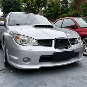 Close-up showing the precision fitment of the center grill overlay over the factory Subaru badge housing