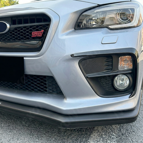 Aggressive carbon print fog light accent trim installed on a 2015 Subaru WRX STI