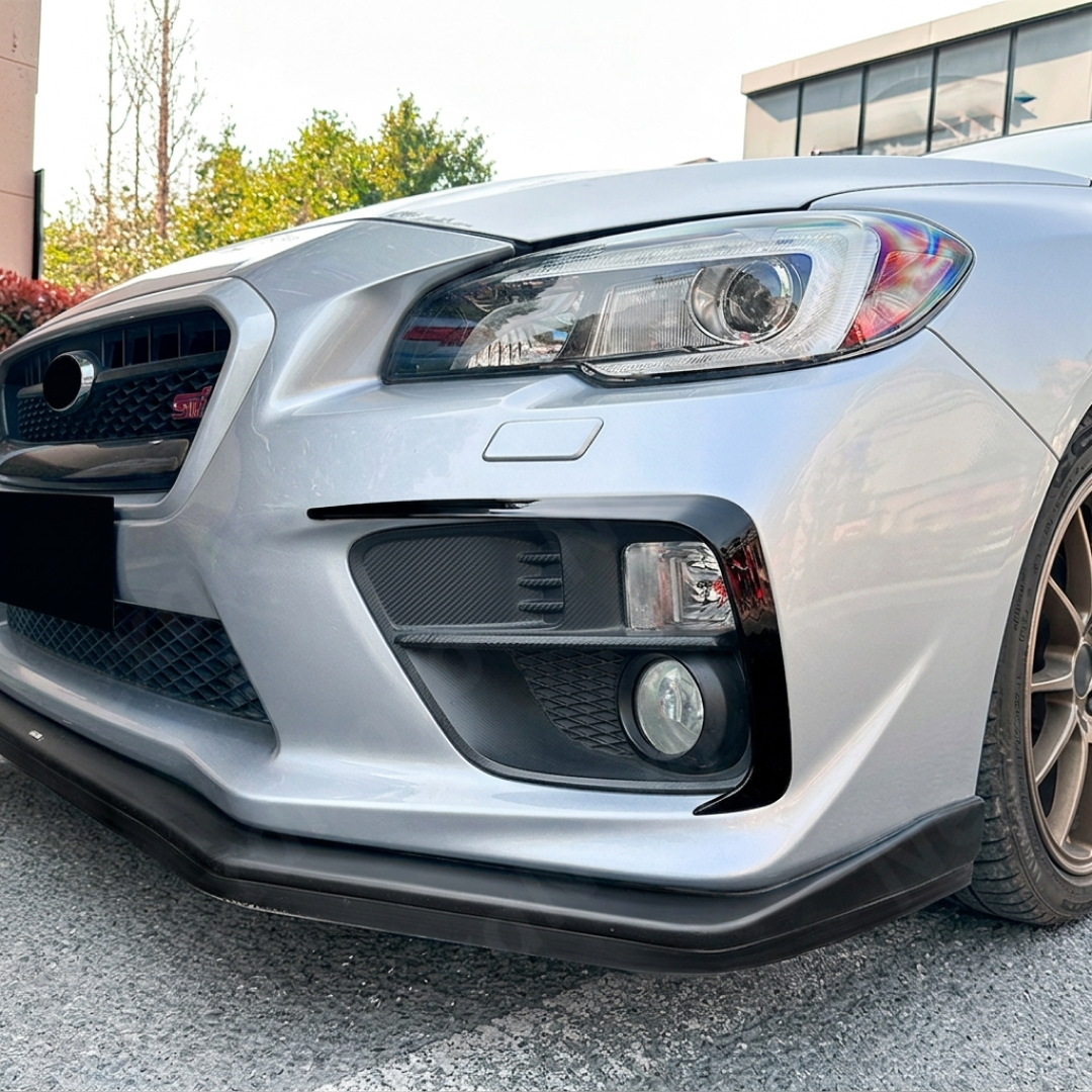 Gloss black fog light accent trim overlays installed on a 2016 Subaru WRX STI VA