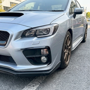 Direct front-facing view of the gloss black fog light bezel overlays for 2015-2017 Subaru WRX