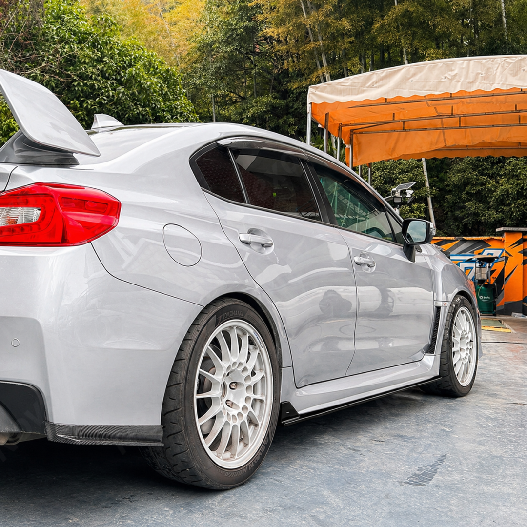 Low-angle perspective highlighting the sleek, ground-hugging profile of the gloss black JDM extensions