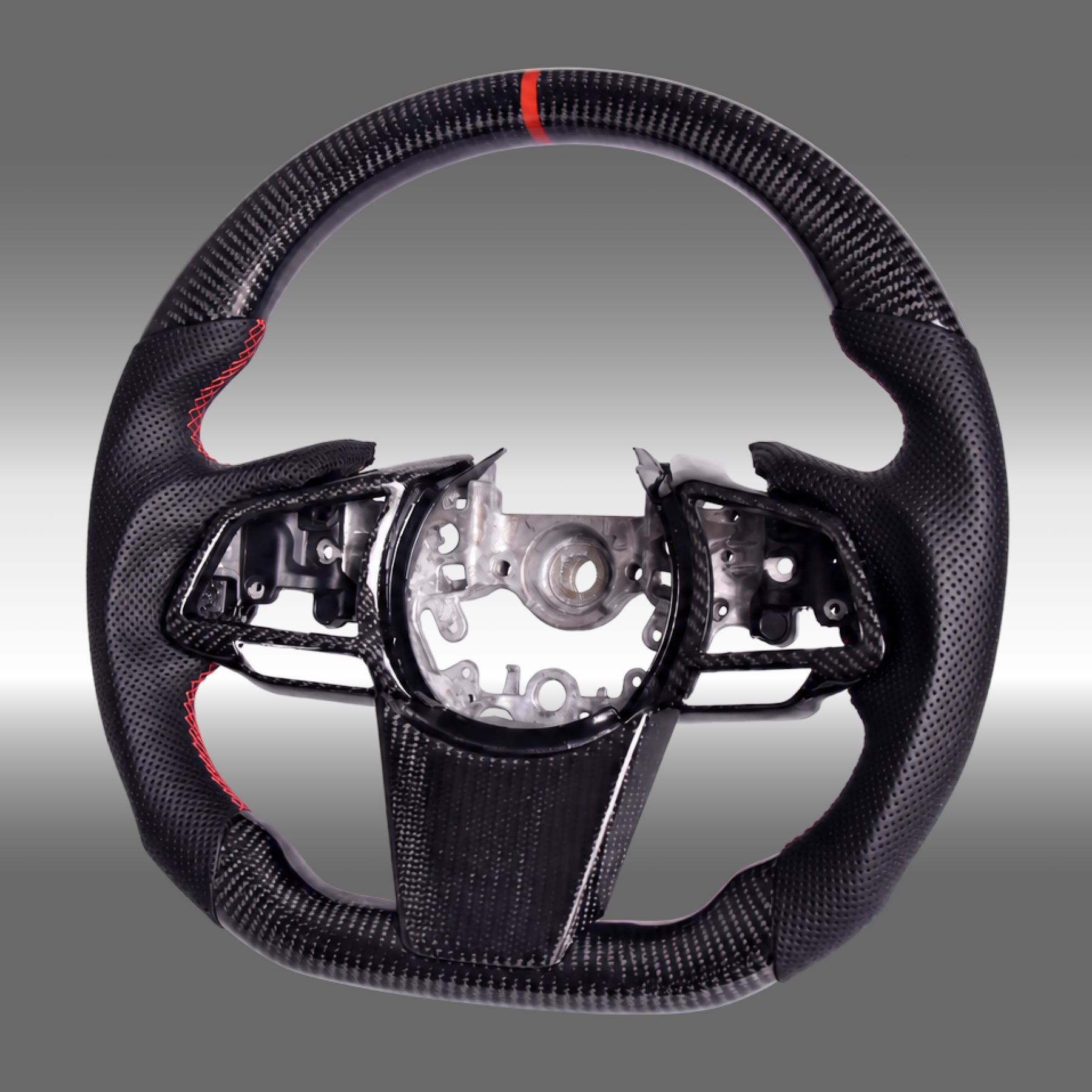Custom 3K gloss carbon fiber sport steering wheel with perforated leather and red center stripe installed in a 2022-2027 Subaru WRX cockpit