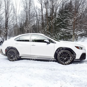High-gloss NexaNovo real carbon fiber wide body fender flares contrasting beautifully with the white paint on a 2024 Subaru WRX VB