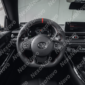 Side angle perspective highlighting compatibility with factory paddle shifters behind the thickened leather grip