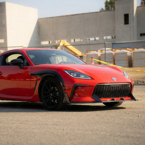 Full 3/4 front view of a 2023 Toyota GR86 featuring a NexaNovo high-gloss real carbon fiber lip kit