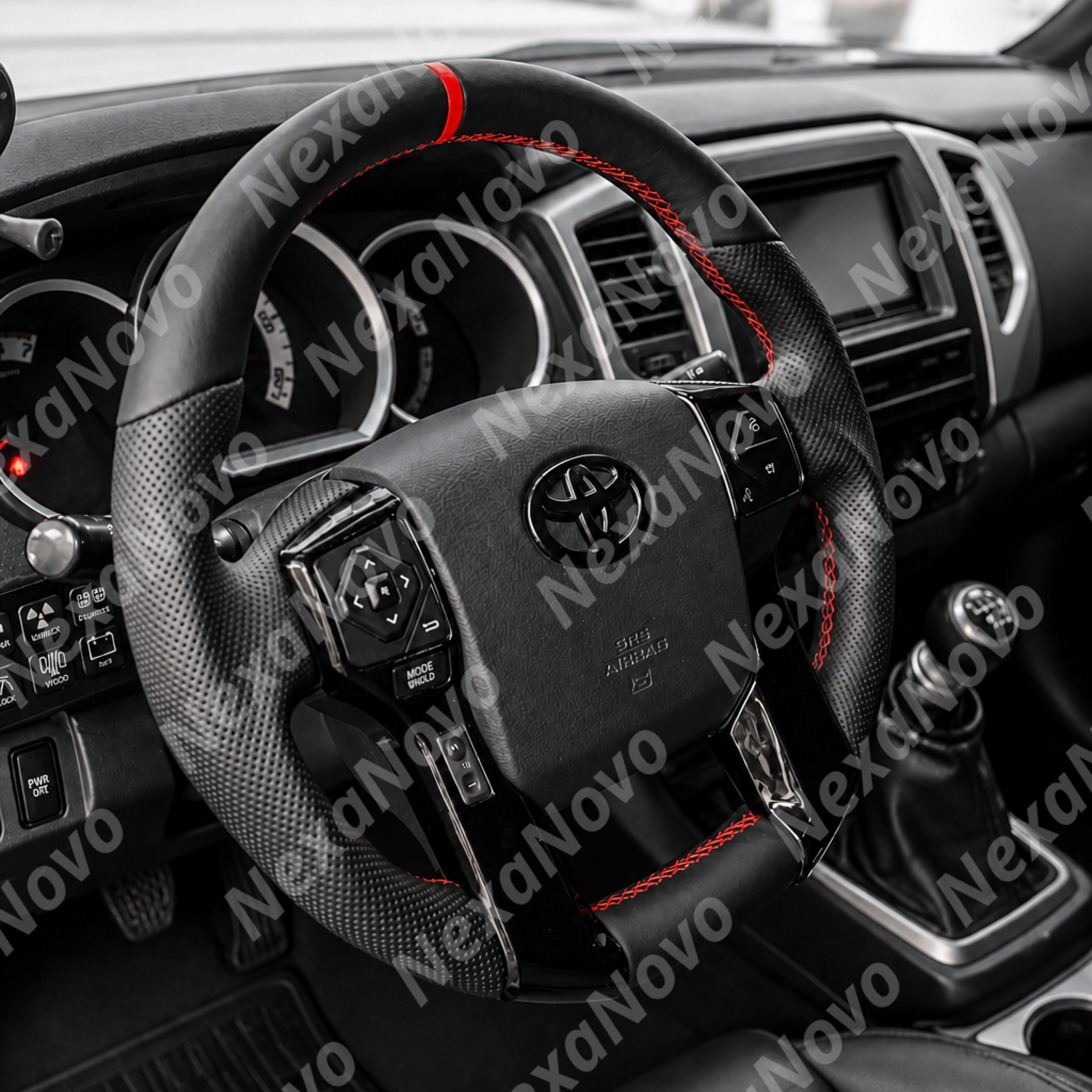 Premium black leather and red contrast-stitched steering wheel mounted in a Toyota Sequoia