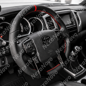 Premium black leather and red contrast-stitched steering wheel mounted in a Toyota Sequoia